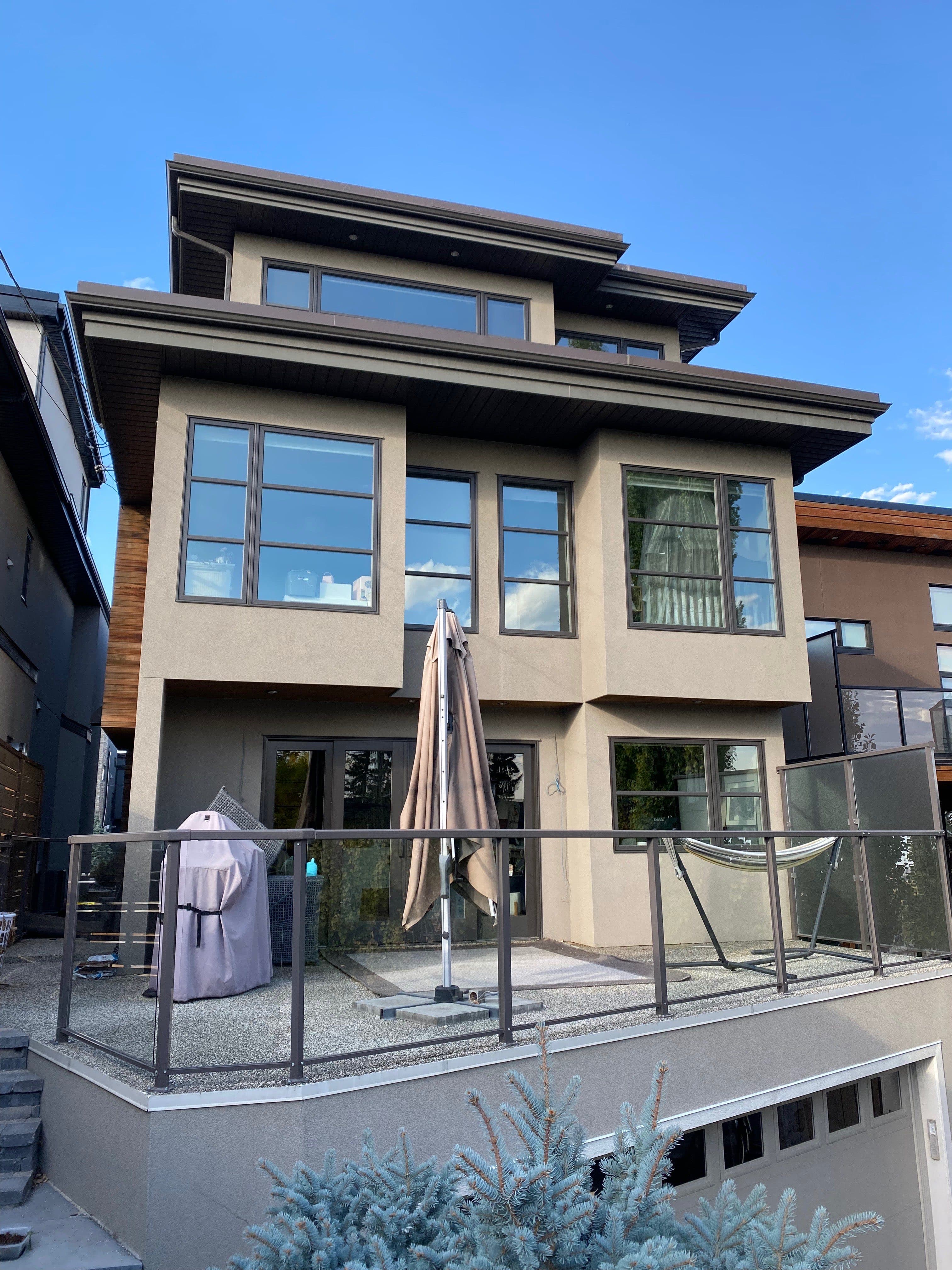 Pressure washing Calgary home exterior — driveway and siding restored with commercial power washing